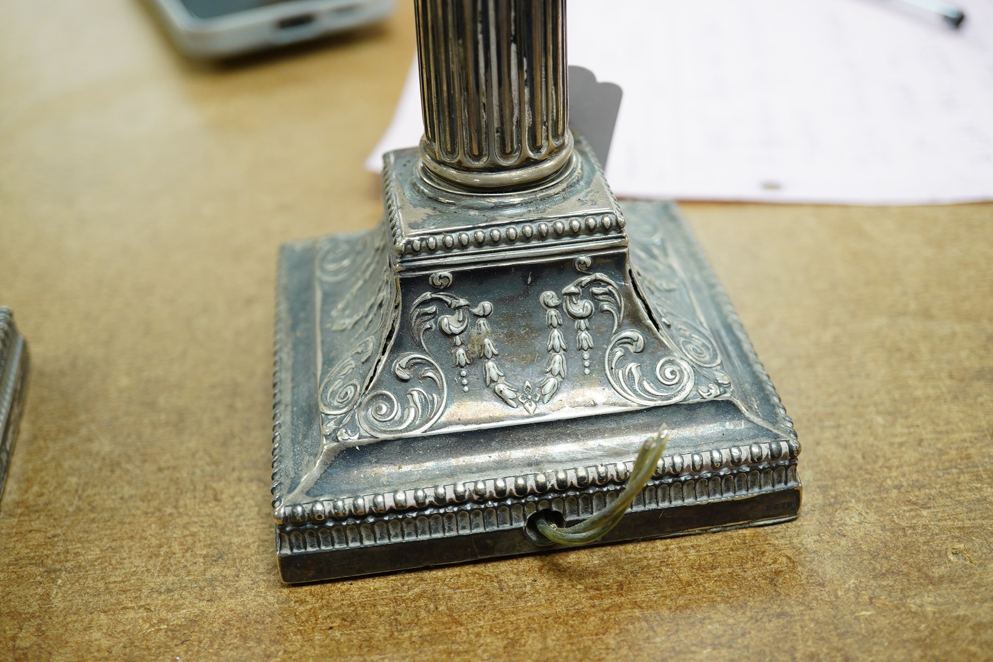 A pair of late Victorian silver Corinthian column candlesticks, now drilled for electricity and converted to lamps, James Dixon & Sons, Ltd, Sheffield, 1894, sticks only 21.8cm, weighted. Condition - poor